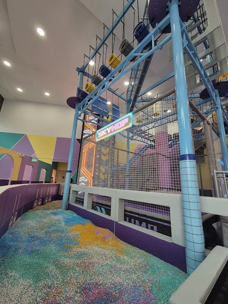 Pastel bead pit under the neon SkyHop sign
